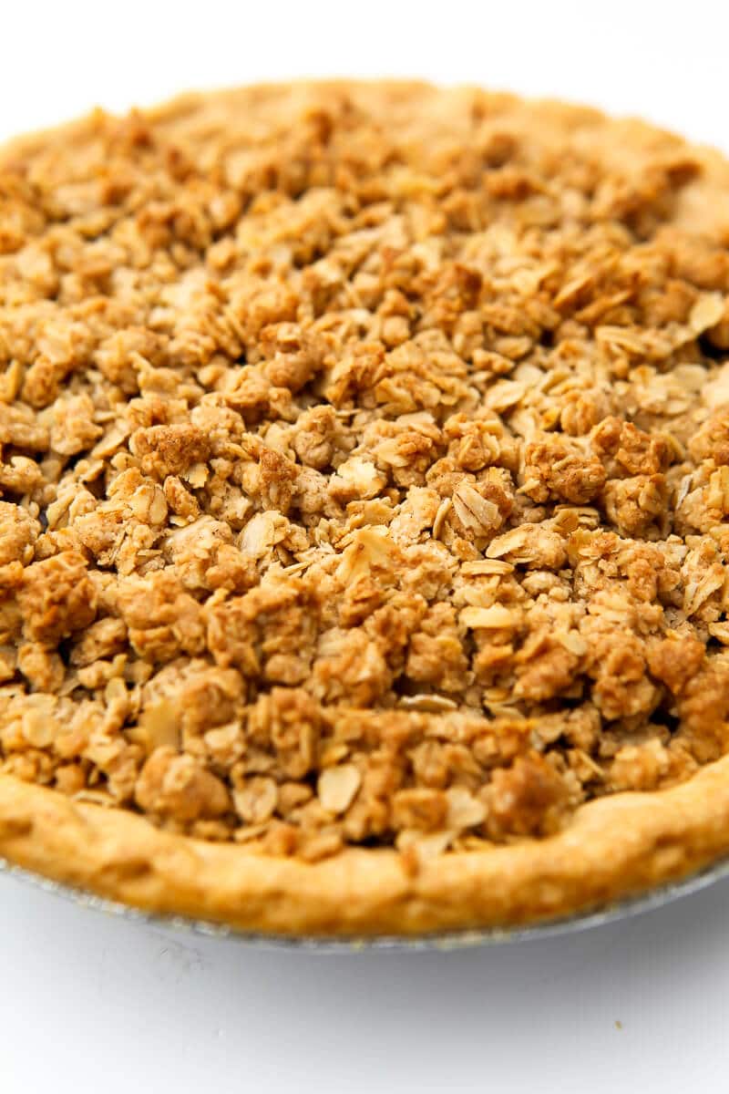 A cherry pie with a vegan crumble topping on a white countertop.