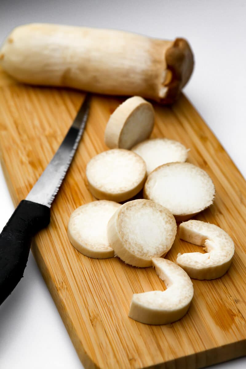 A king oyster mushroom cut into the shape of shrimp.