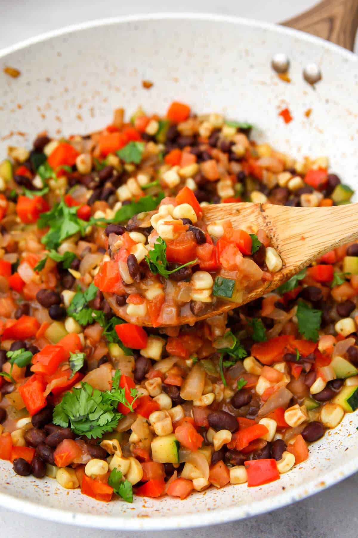 Corn and cilantro added to the veggies and beans.