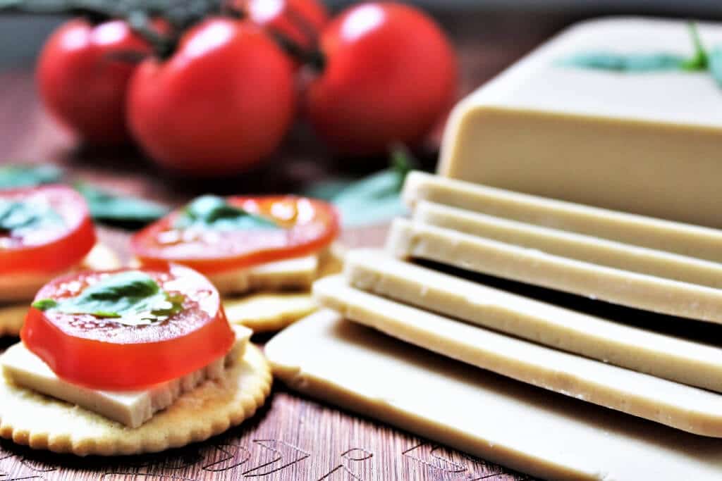 Vegan mozzarella slices with tomato.