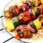 Grilled setian and veggies on kebabs over a bed of quinoa and drizzled with teriaki sauce.