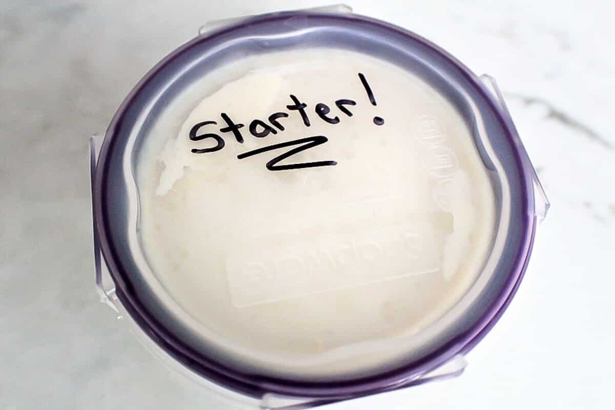 A glass container containing vegan yogurt starter.