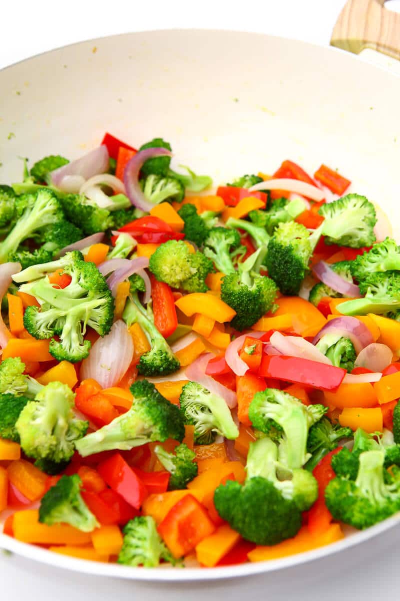Mixed vegetable in a large wok being stir-fried.
