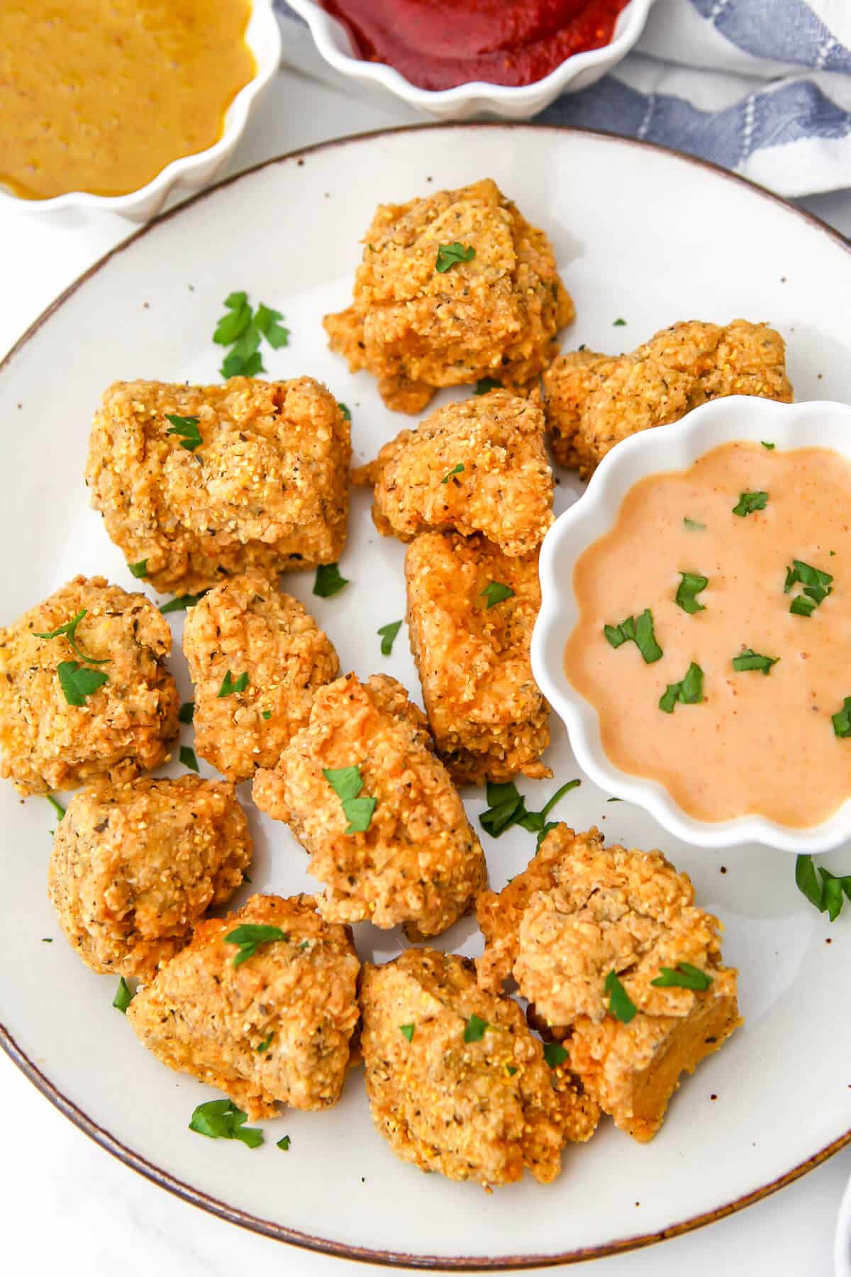 A top view of a plate of fried tofu flavored to taste like KFC chicken.