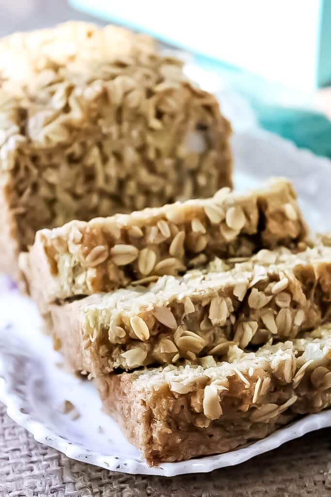 A loaf of sliced vegan beer bread with oats sprinkled on top.