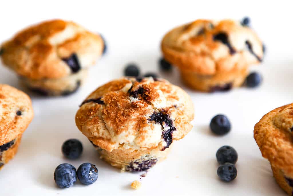 Blueberry muffins baked with cinnamon and sugar on the top.e