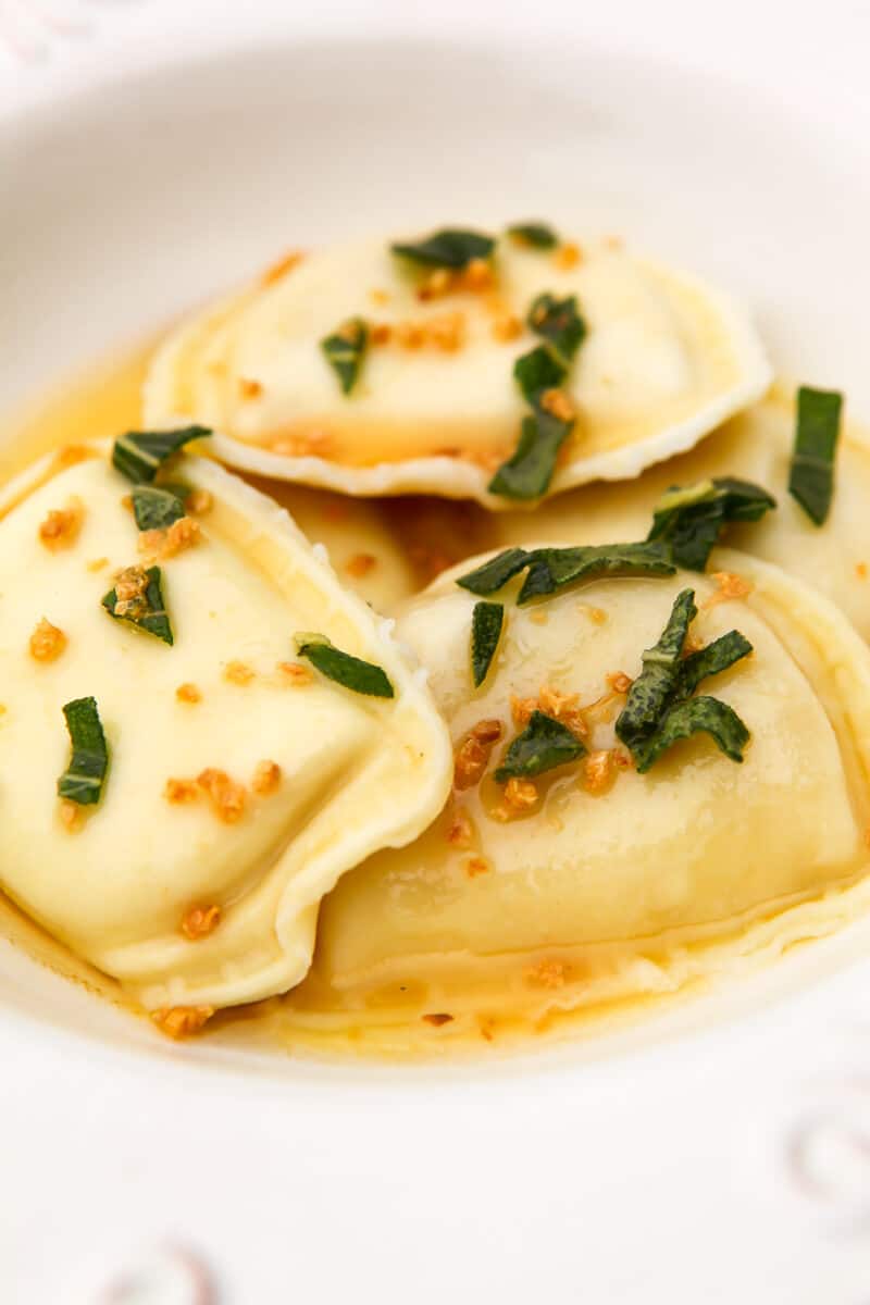 Perogies with vegan brown butter sauce poured over them.