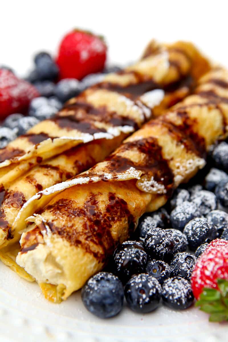 Vegan crepes filled with ricotta, and topped with chocolate sauce.