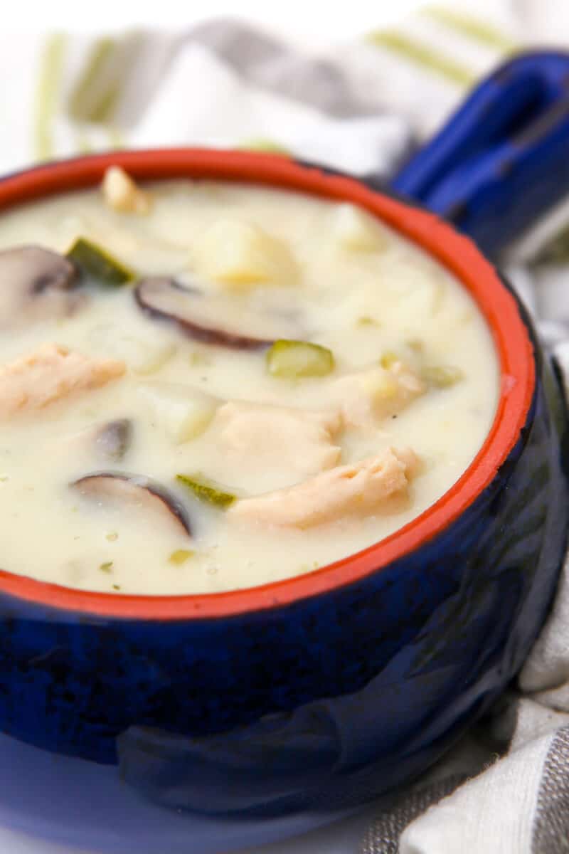 A blue bowl filled with vegan green chile chicken stew.