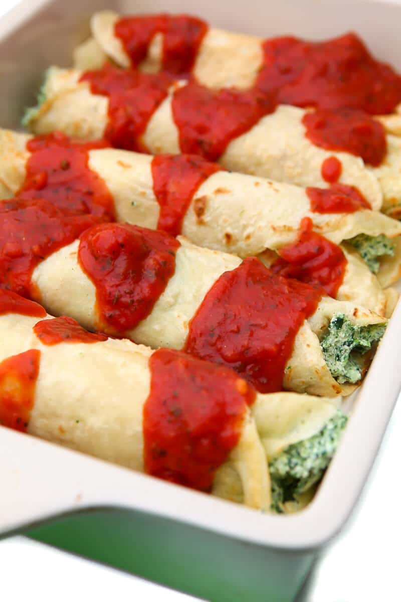 Vegan manicotti made with savory crepes and spinach tofu ricotta.