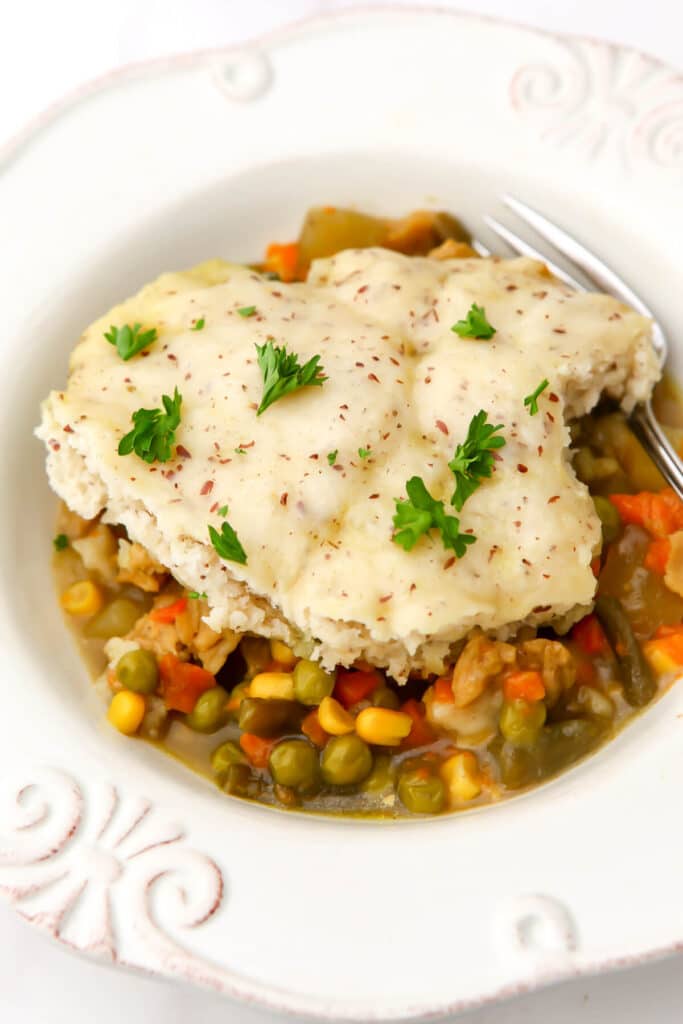 A top view of a vegan pot pie served on a white plate.