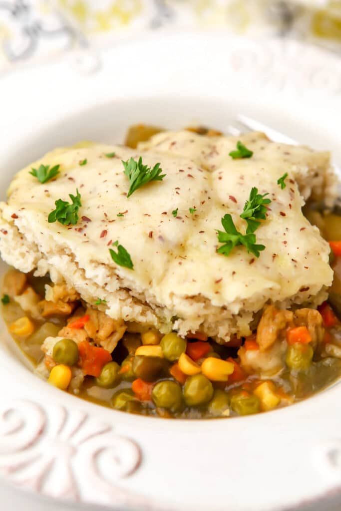 Vegan pot pie with a biscuit topping made in a slow cooker.