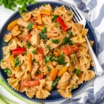 A top view of a plate full of vegan rasta pasta made with bell peppers, vegan chicken, and bow tie pasta.