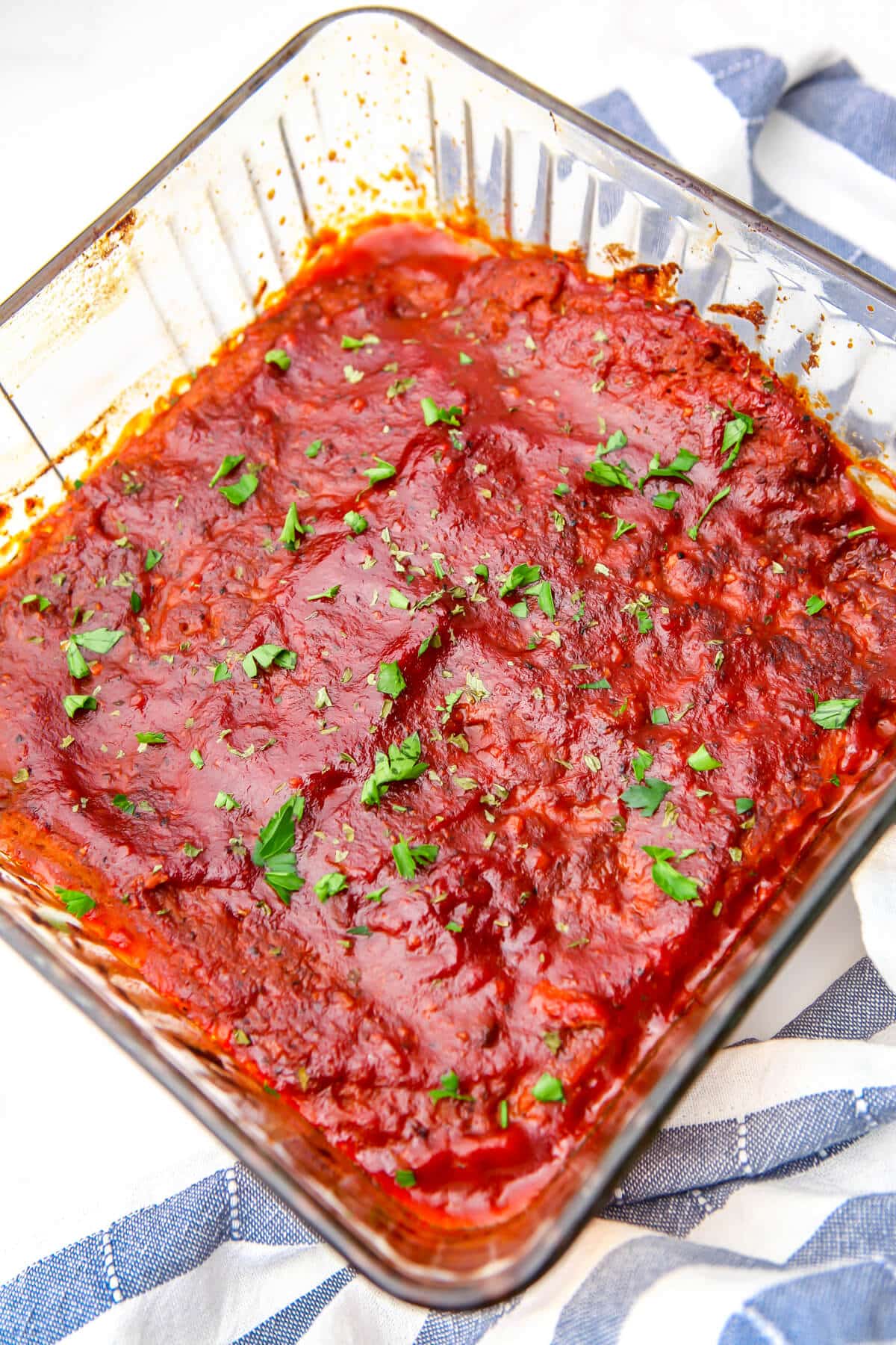 Seitan ribs in a baking dish and covered with vegan BBQ sauce after baking.