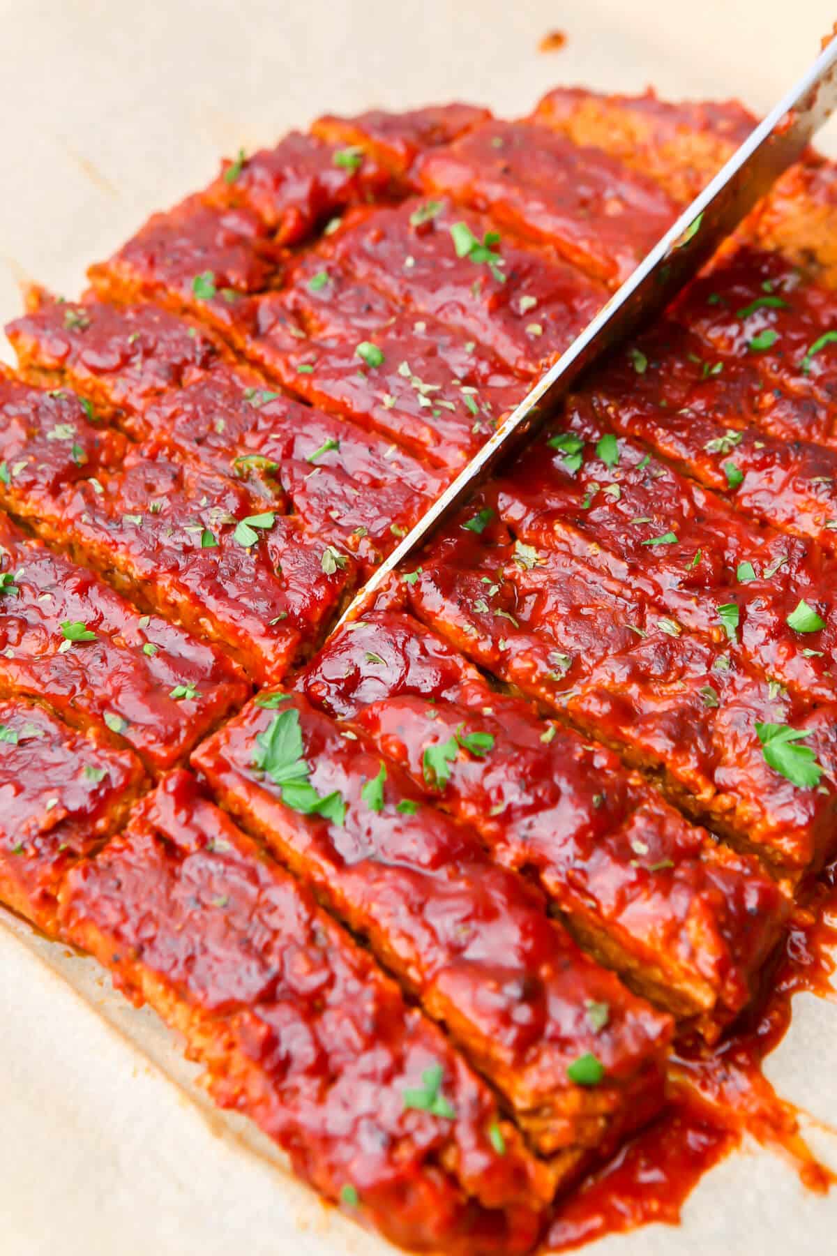 Vegan ribs being cut into strips.