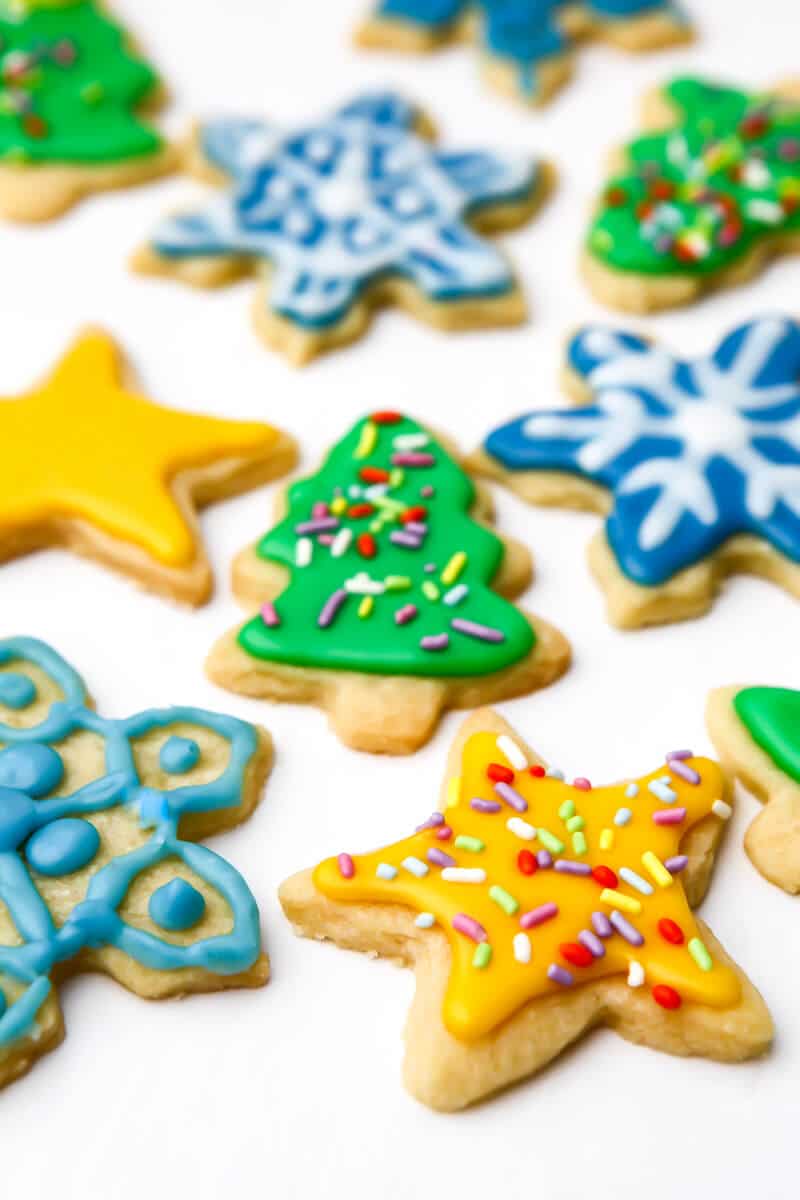 Vegan cut out cookies decorated with vegan royal icing in bright colors.
