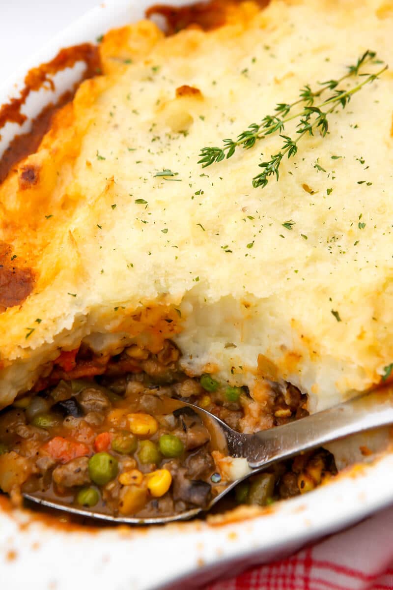 A vegan cottage pie made with beyond beef crumbles with a scoop taken out of it.