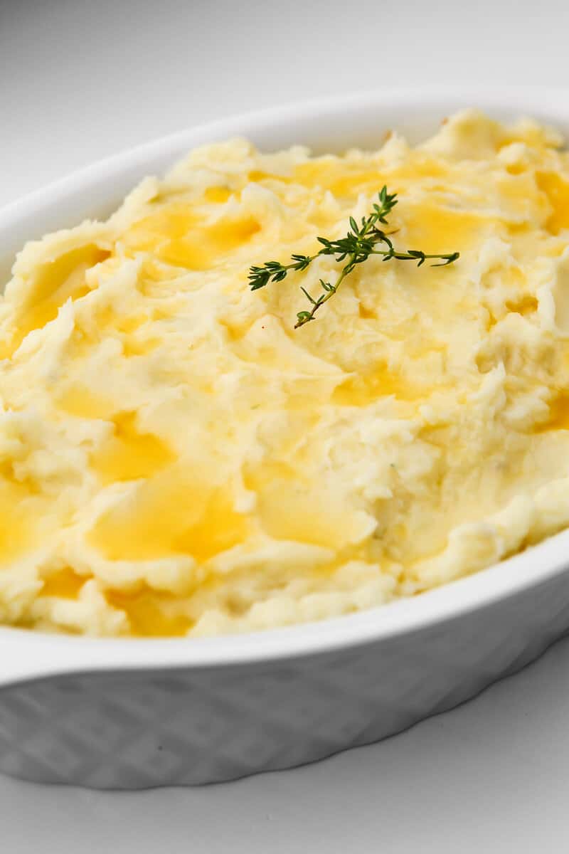 A vegan cottage pie covered with mashed potatoes and butter before it goes in the oven.