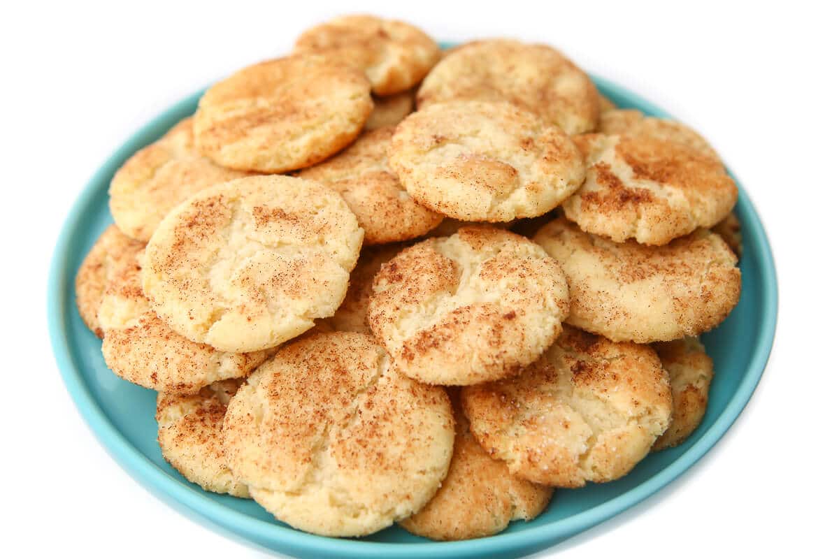 A top view of a plate of snickerdoodle cookies on a blue plate.