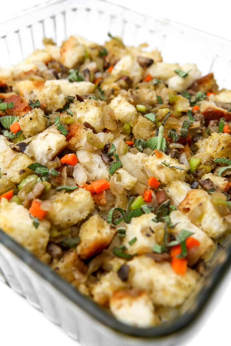 The vegan stuffing in a glass baking dish before baking in the oven.