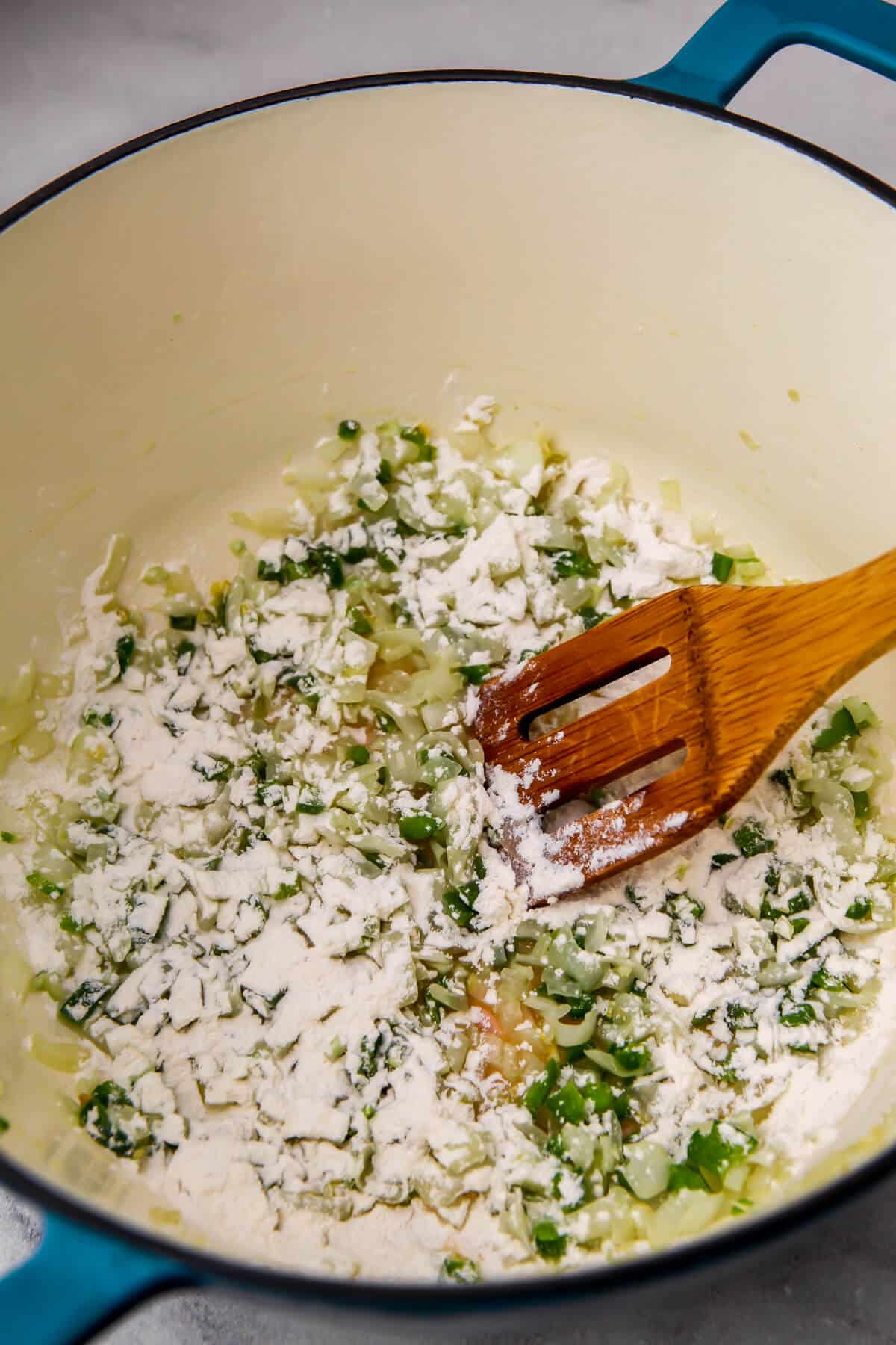 Flour added to the onions and jalapenos to make a roux.