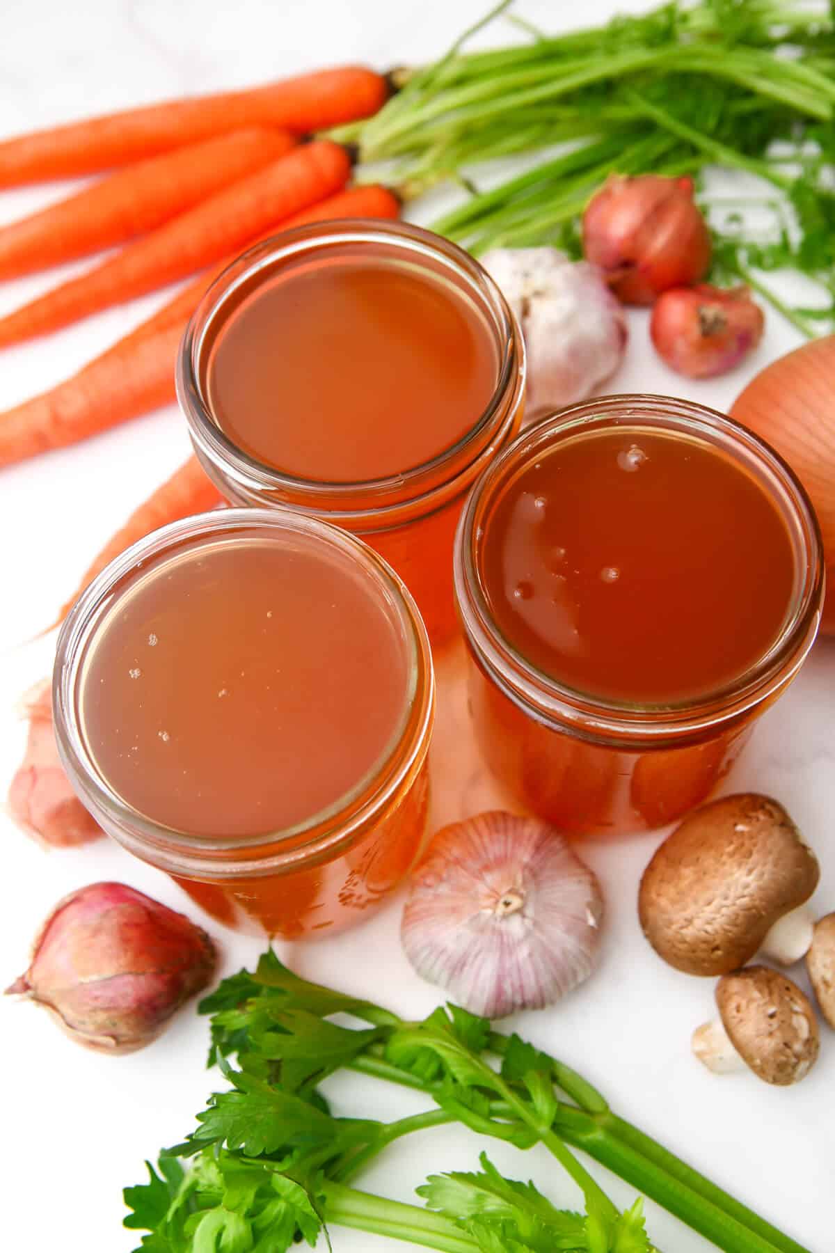 Vegan broth made from veggie scraps in mason jars.